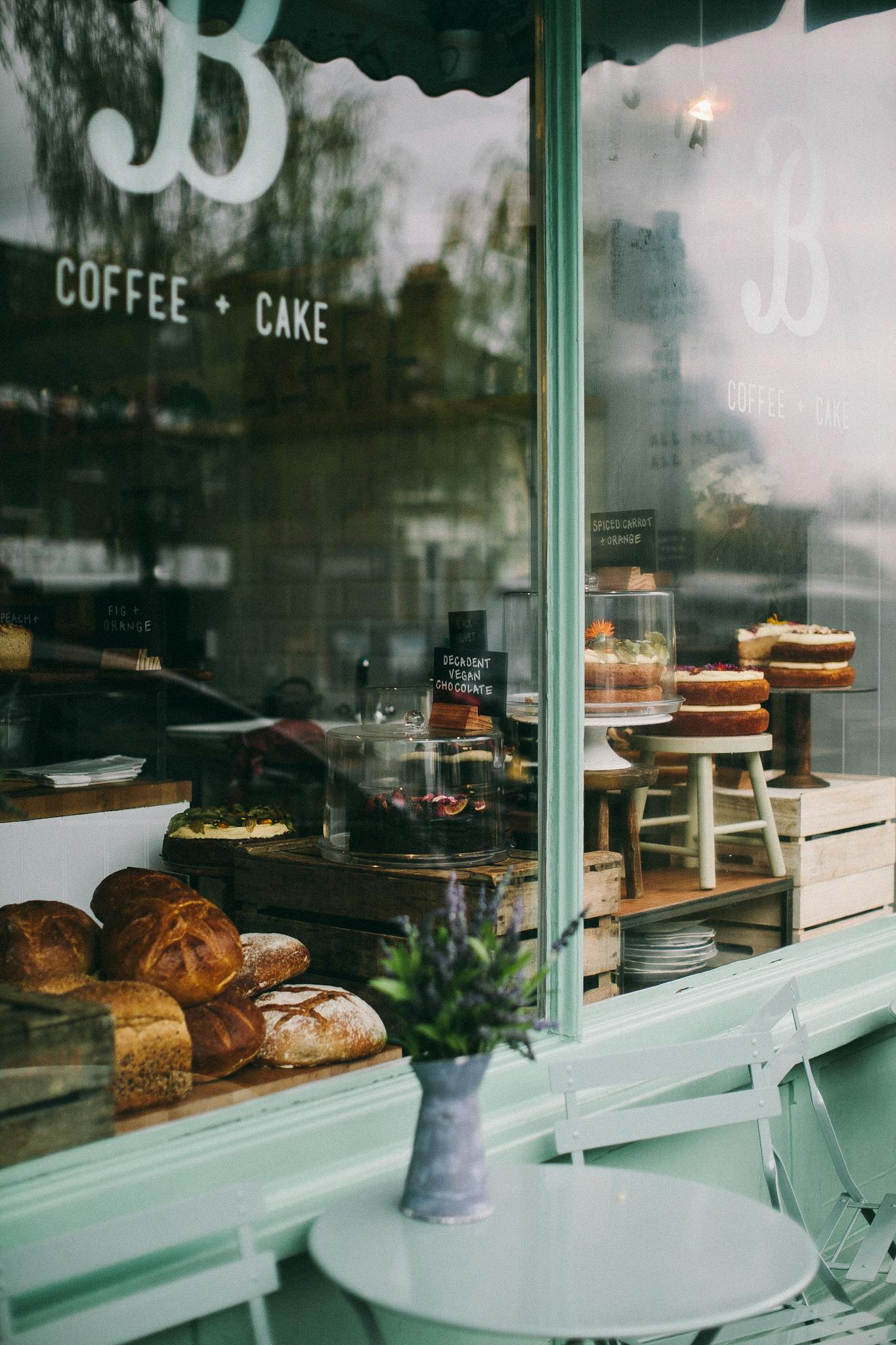 Events - Warm and inviting cafe window display in Oxford showcasing fresh baked goods and cakes.