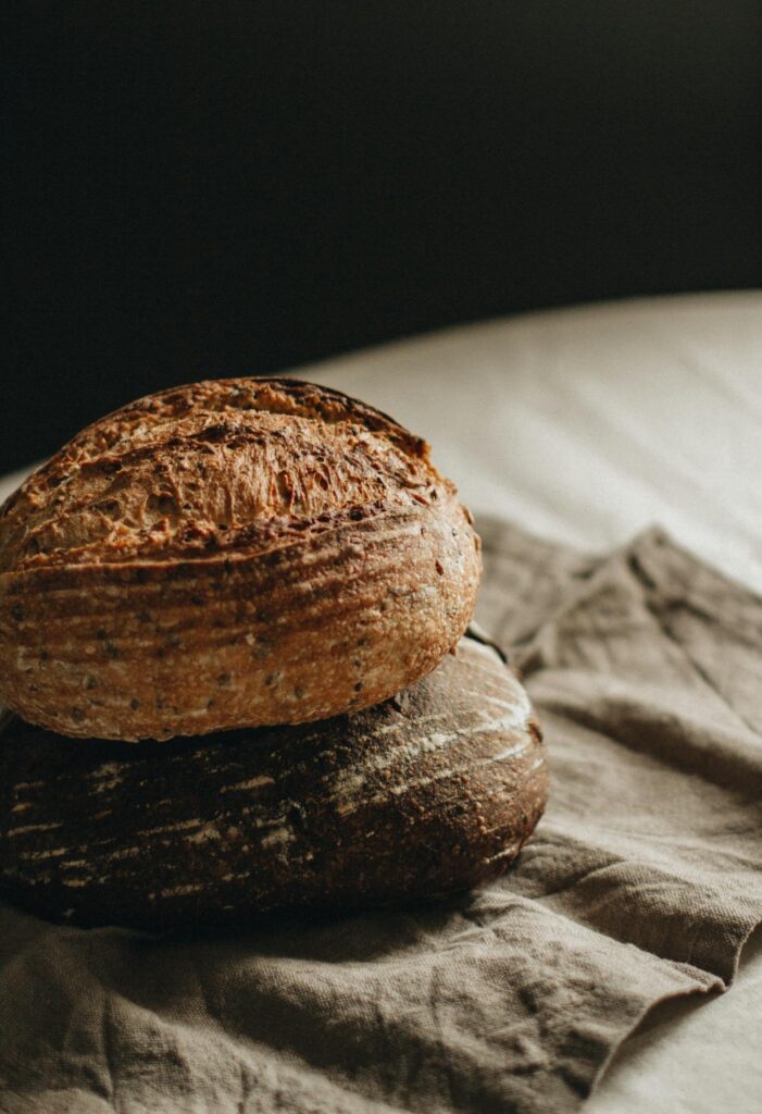 Warm artisan sourdough loaves placed on rustic linen for a homemade touch.